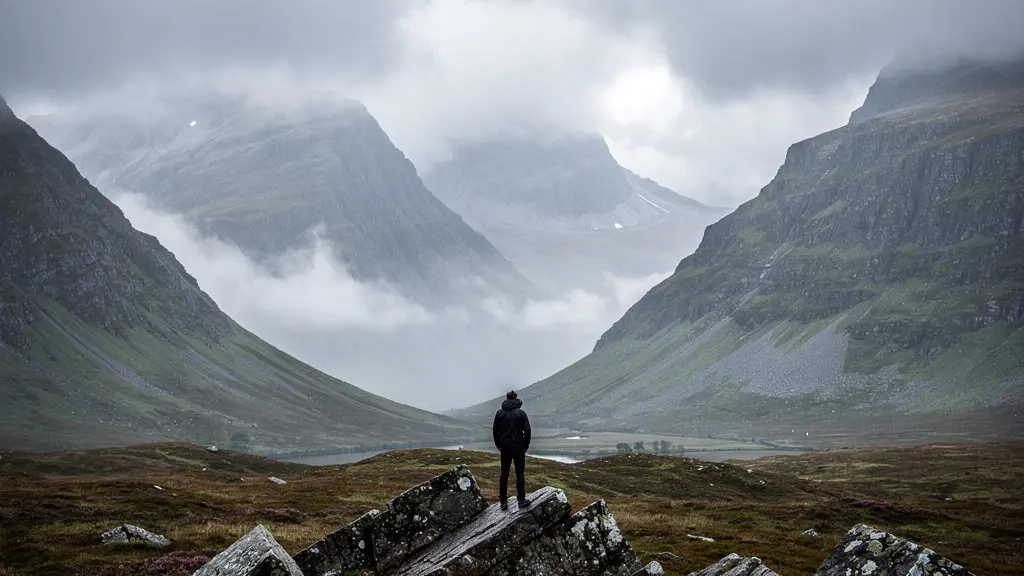 Dramatic Scottish Highland landscape with misty mountains under overcast skies