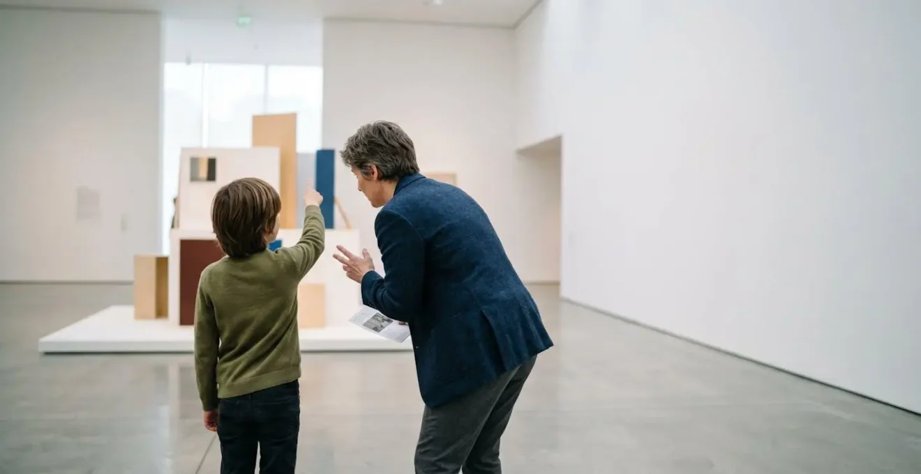 Child and adult visitor collaboratively exploring museum exhibition with shared curiosity